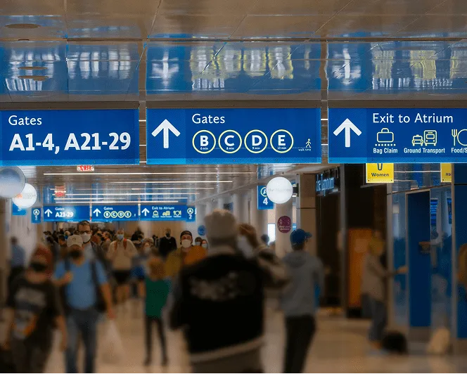 Global travelers moving through airport terminal